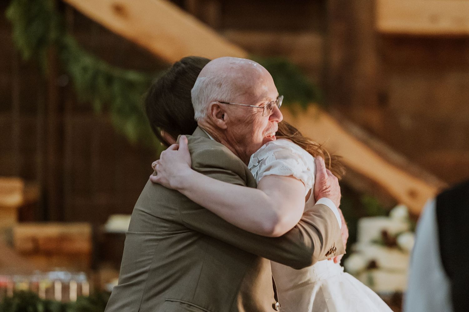 An old man gives the bride a hug