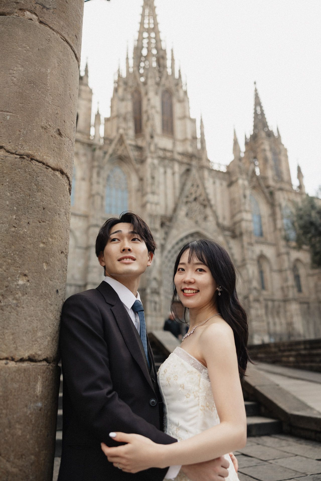 A black and white wedding photo sequence shows a couple playfully running through a stone corridor.