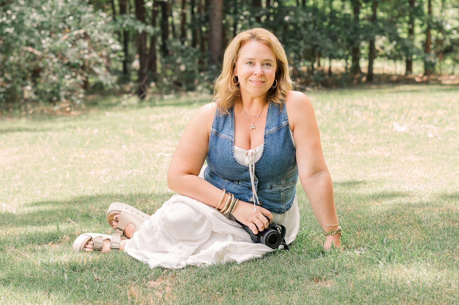 Female photographer in a field posing with a camera Newnan GA
