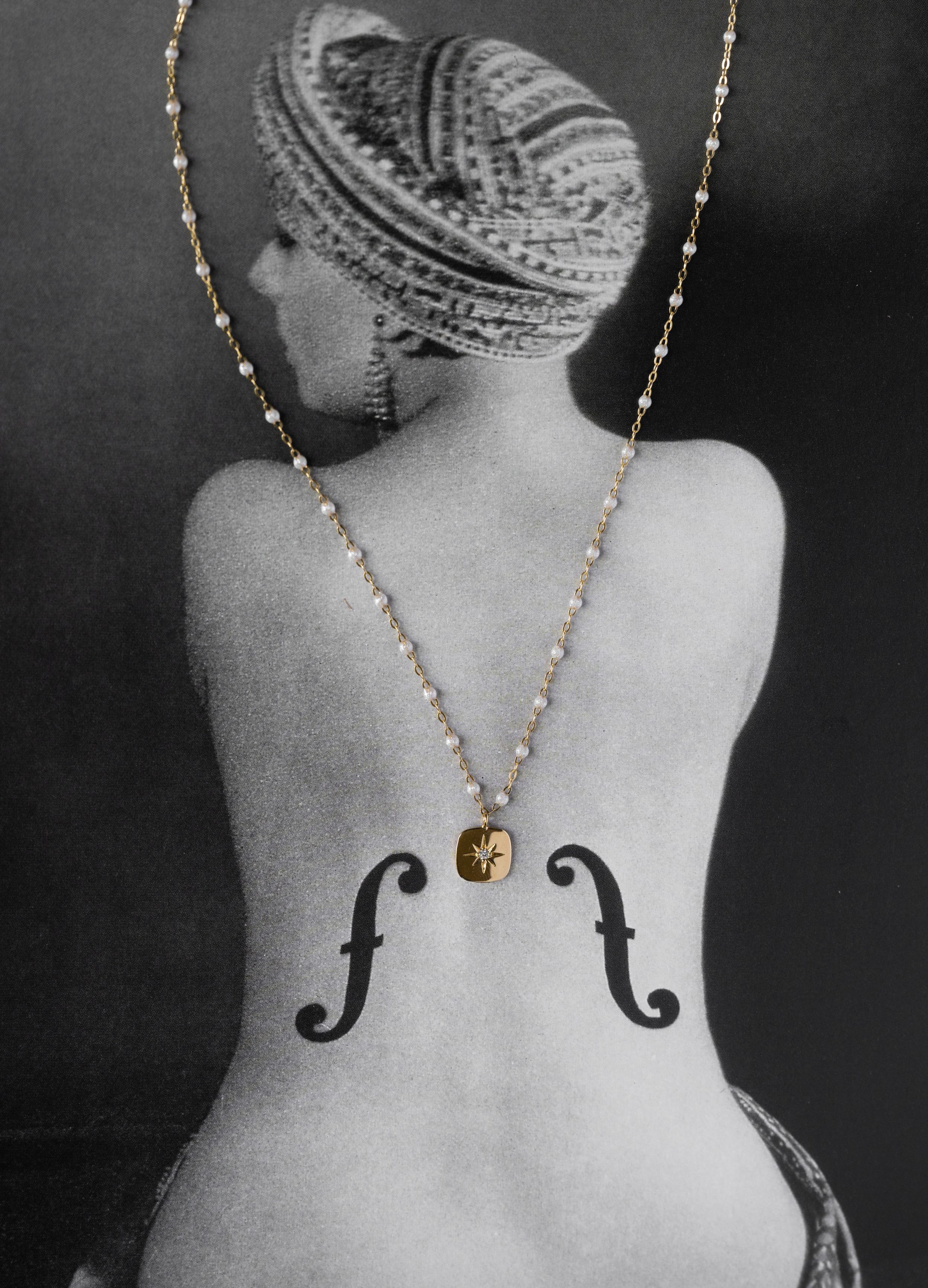 Man Ray's Le Violon d'Ingres, a surrealist photograph of a woman's bare back with f-holes and a pearl necklace.