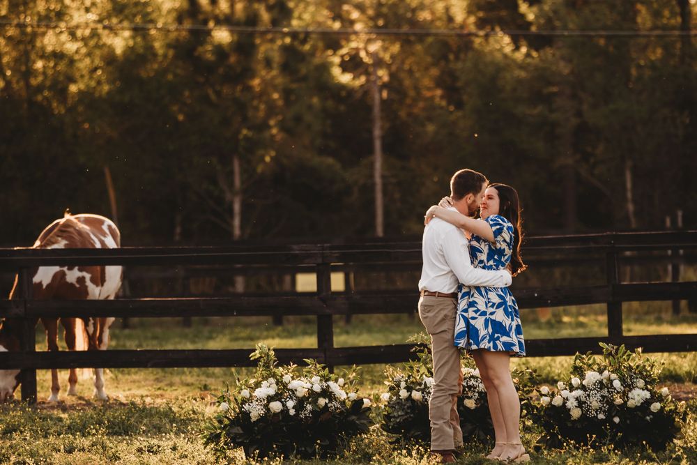 Romantic engagement photo with horse in background at a Florida stable during sunset