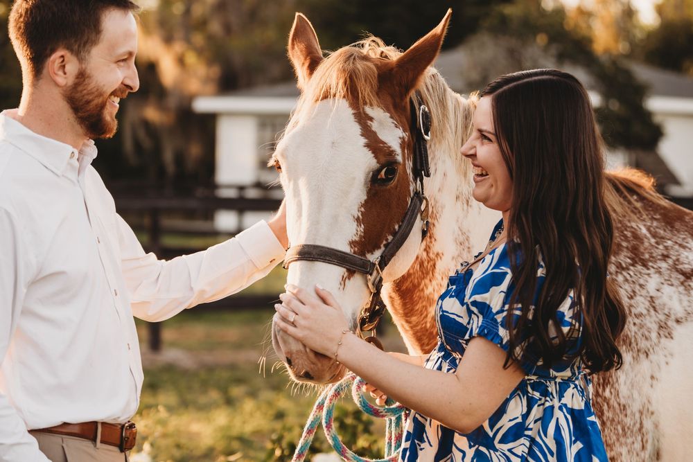 Couple walking together after a romantic proposal at a Florida horse stable during sunset