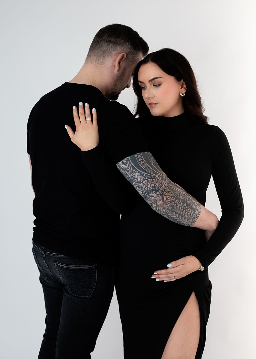 Four intimate dance poses in black attire shown in sequence against a white backdrop.