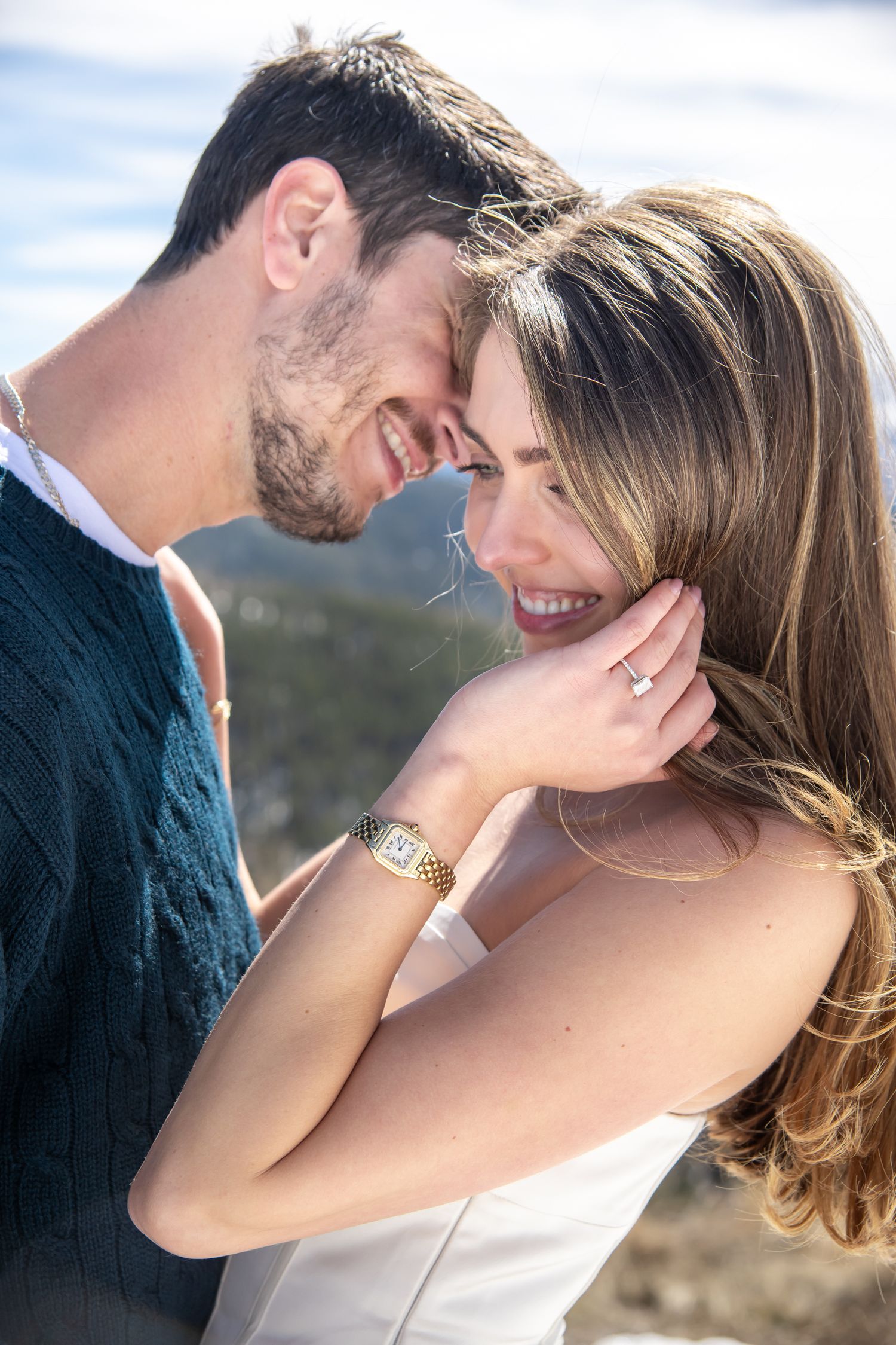 Happy couple smiling and touching foreheads and embracing for Vail Colorado engagement photo session.