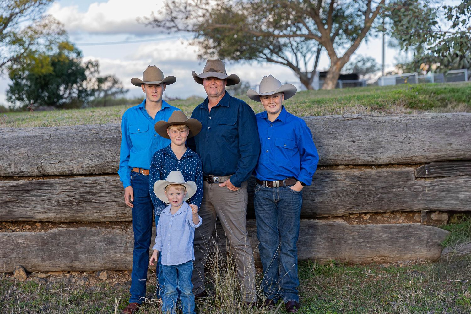 father and sons standing in front of a loading ramp for father's day mini photo shoot