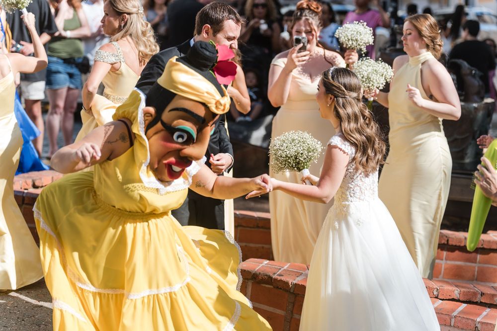 Bride dancing with traditional vejigante character during lively Old San Juan wedding celebration