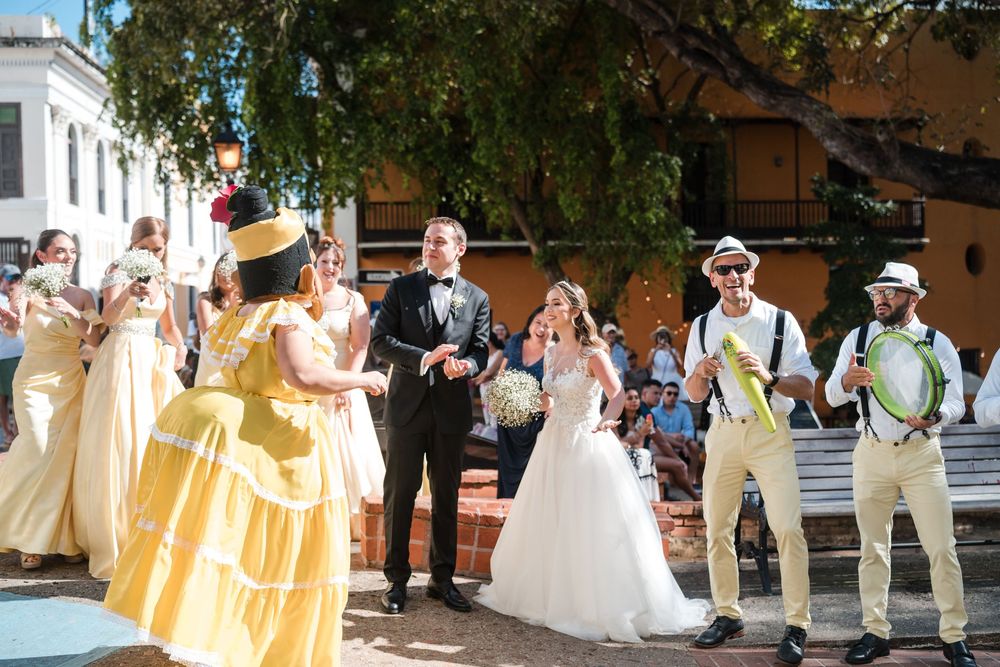Bride and groom celebrating with a lively plena group and guests in Old San Juan wedding procession