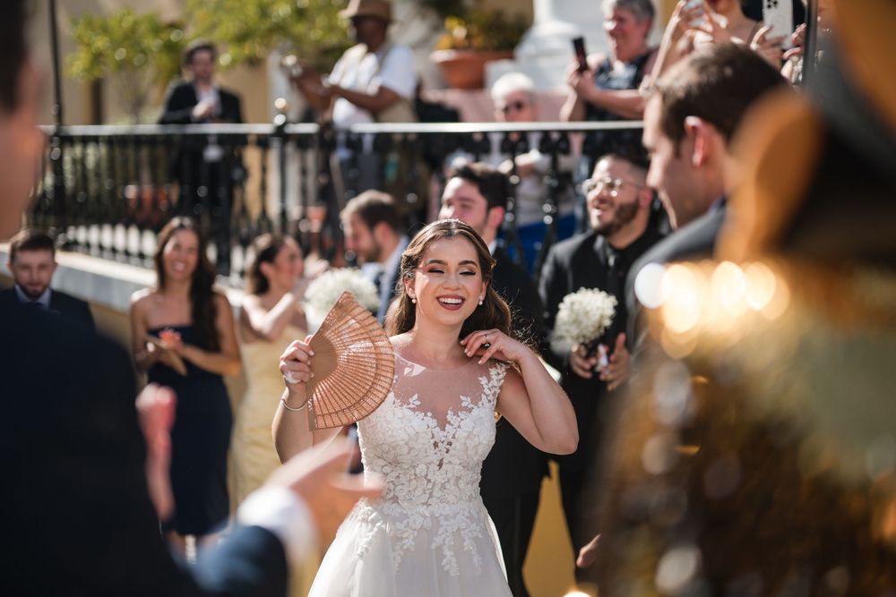Bride smiling while dancing with guests during Puerto Rico wedding parade in Old San Juan