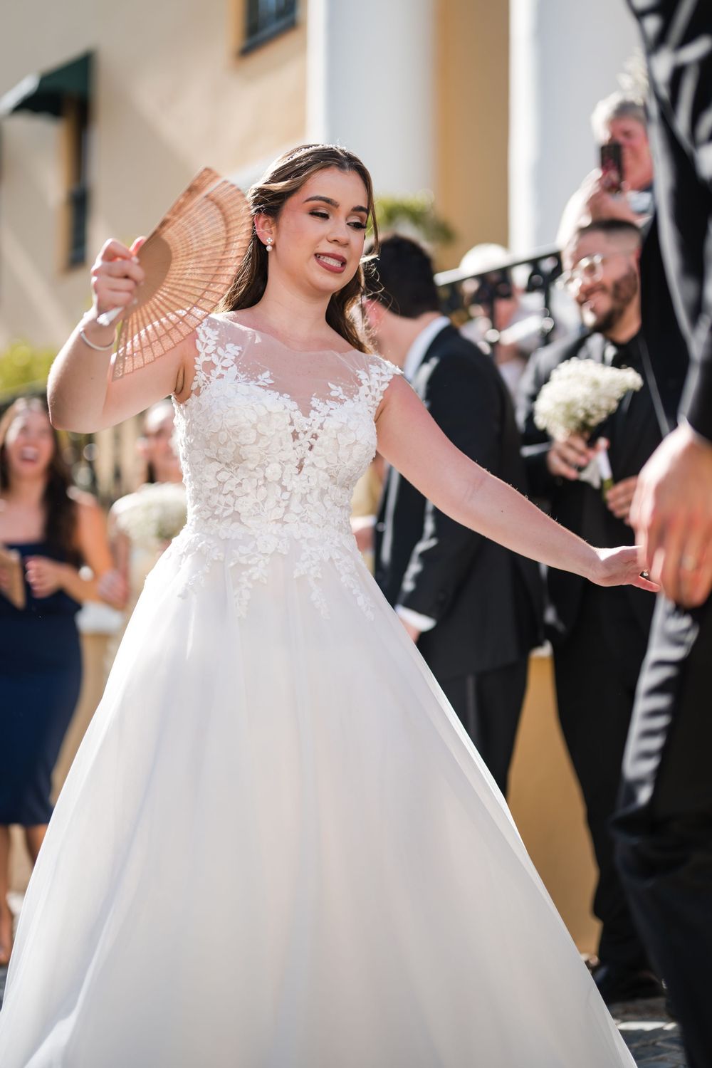 Bride dancing with guests during lively plena parade in Old San Juan wedding celebration