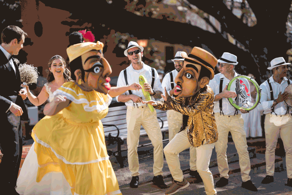 Vejigante performers and live band leading wedding parade through streets of Old San Juan