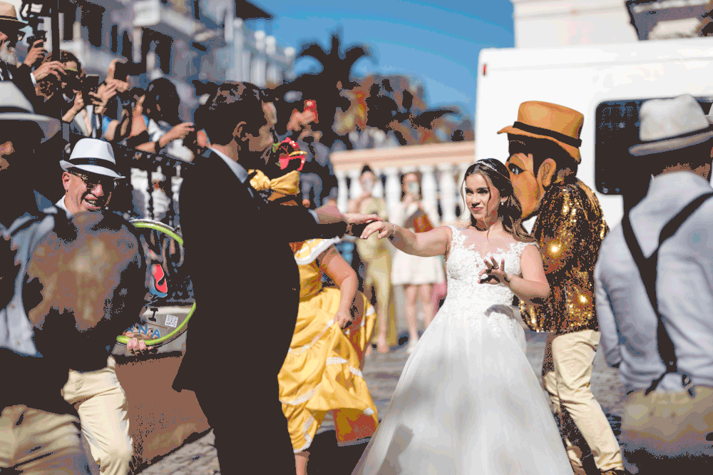 Bride dancing with live plena musicians during wedding parade in Old San Juan Puerto Rico