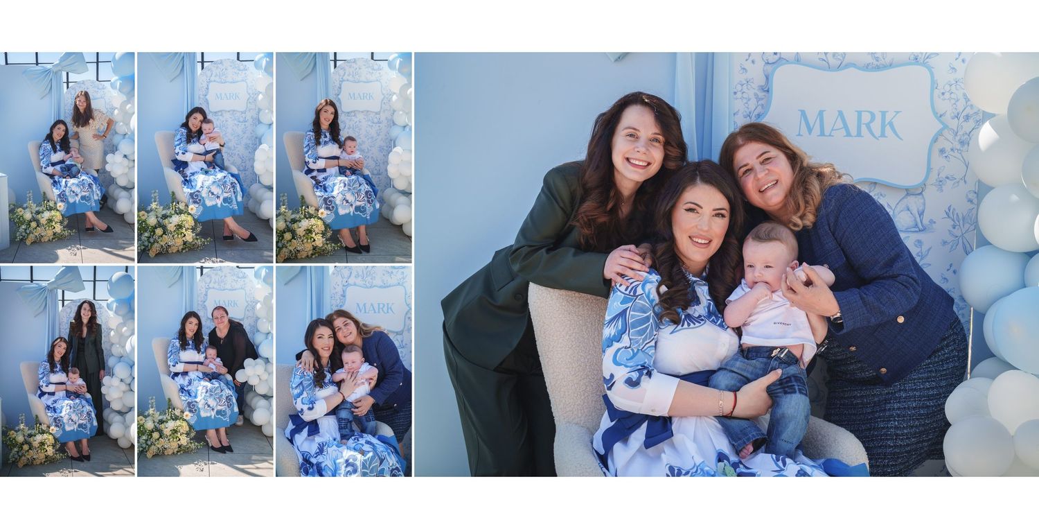 Family portrait session with blue and white balloon decorations and floral arrangements in a photo studio setting.