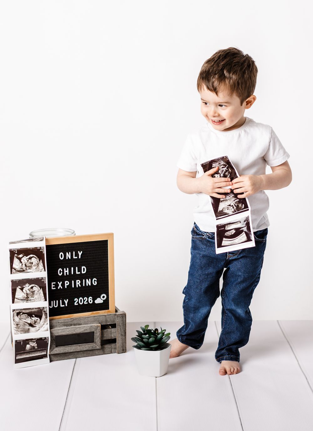 studio maternity session mom son ultrasound on white