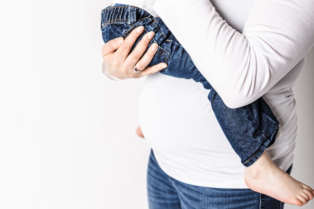 studio maternity session mom son ultrasound on white  detail shots