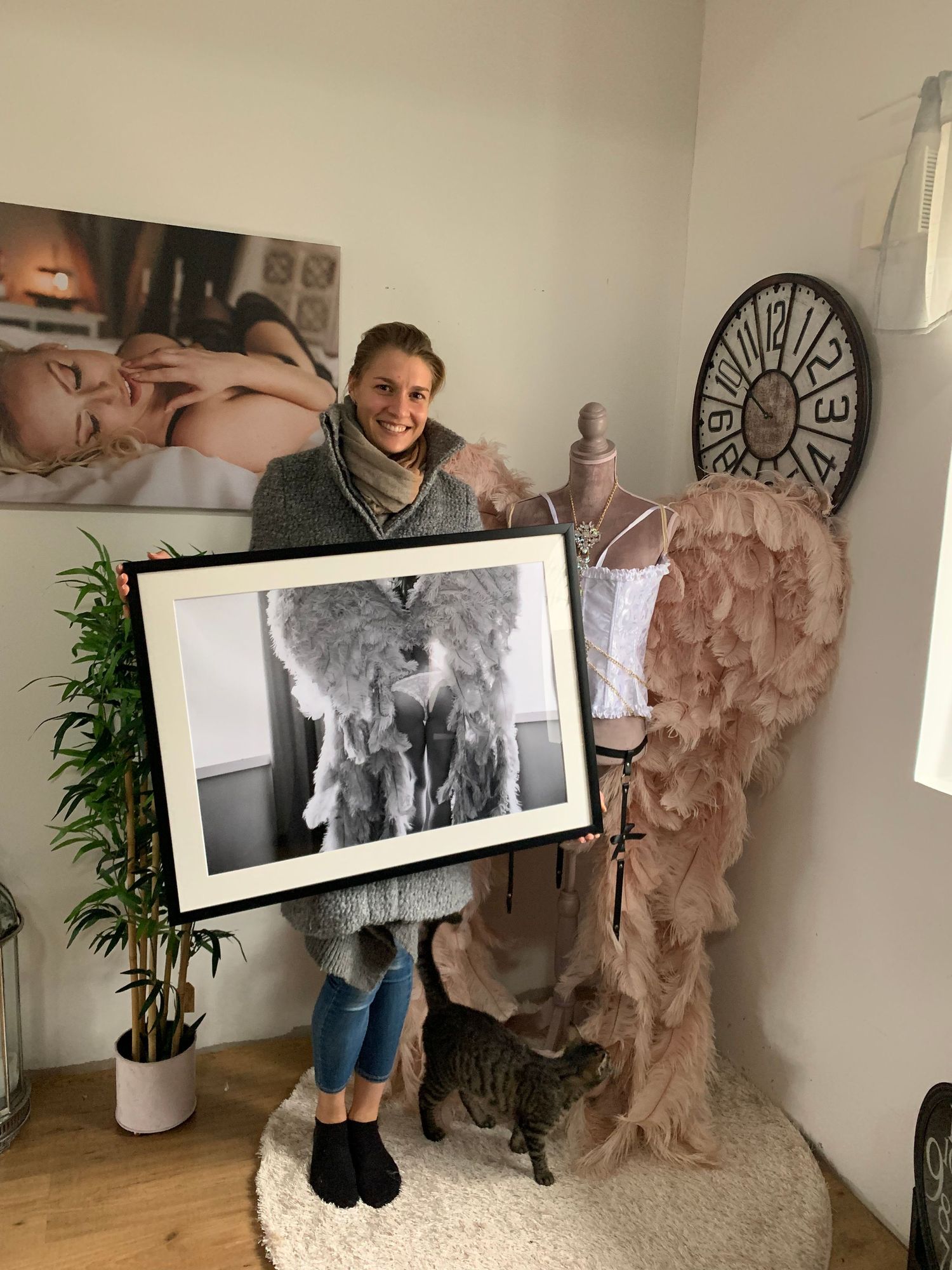 Kund hämtar en tavla på en bild från hennes boudoir morgongåva fotografering med Fotograf Jane Svensson.
