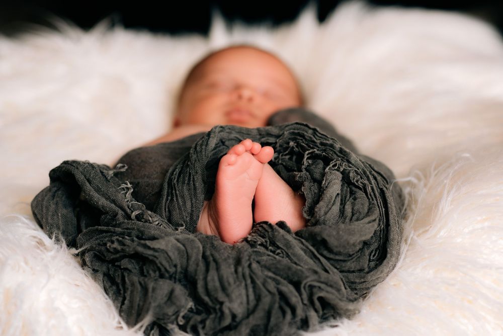 an image of a newborns precious little feet during his in home newborn session