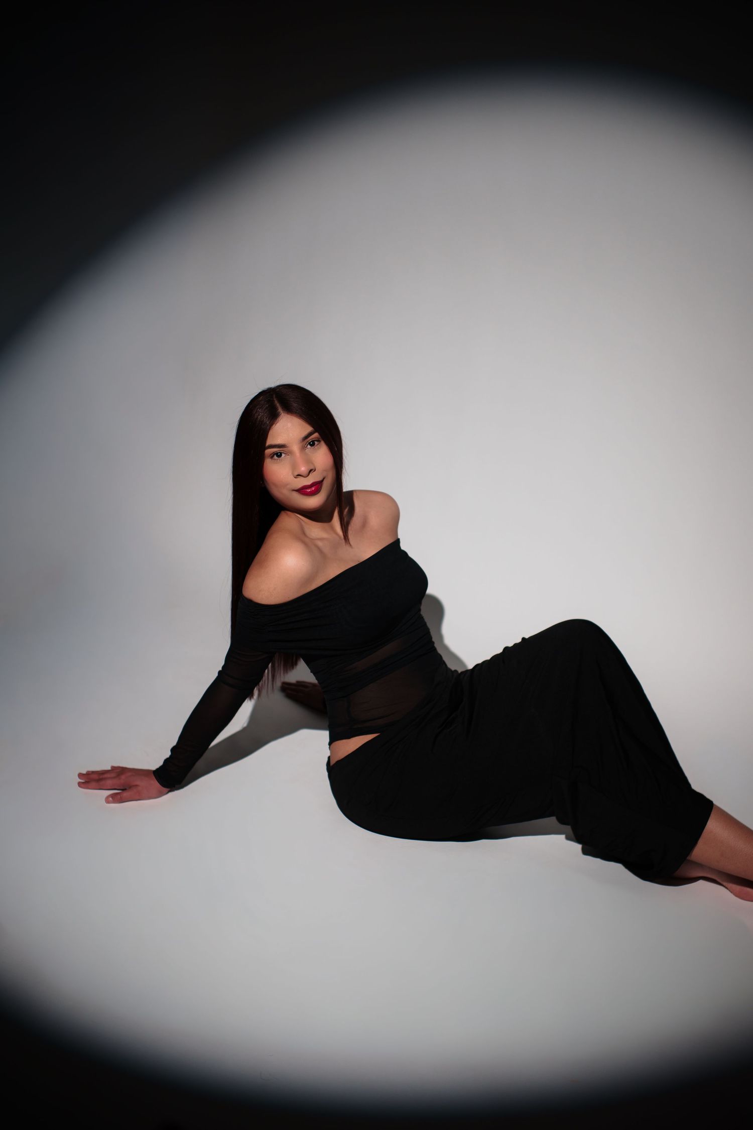 Artistic fashion photo series showing a model in black attire posing dramatically against a white background with vignette lighting.