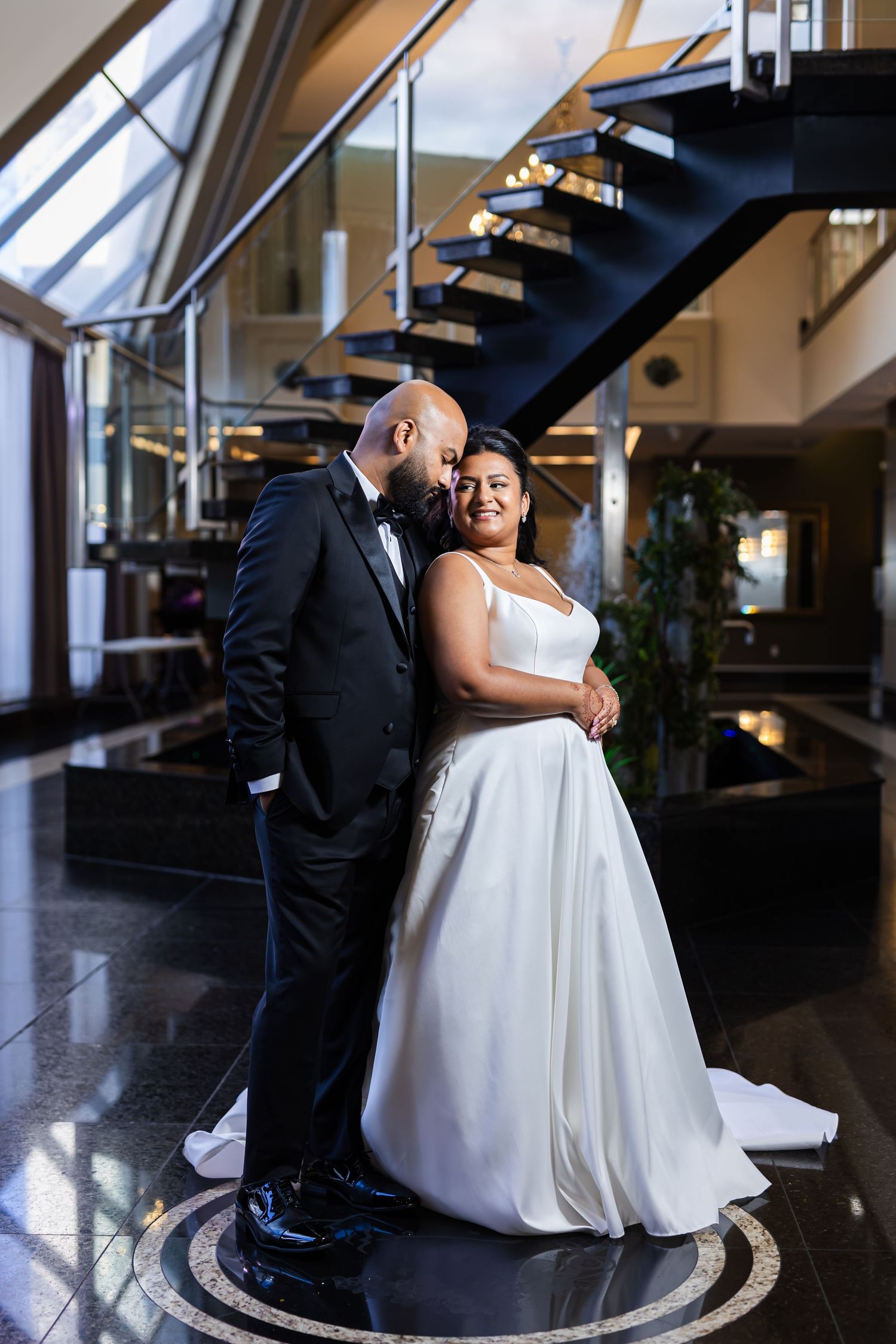 A romantic wedding couple shares a tender moment in a series of photos with dramatic lighting and flowing white dress details.