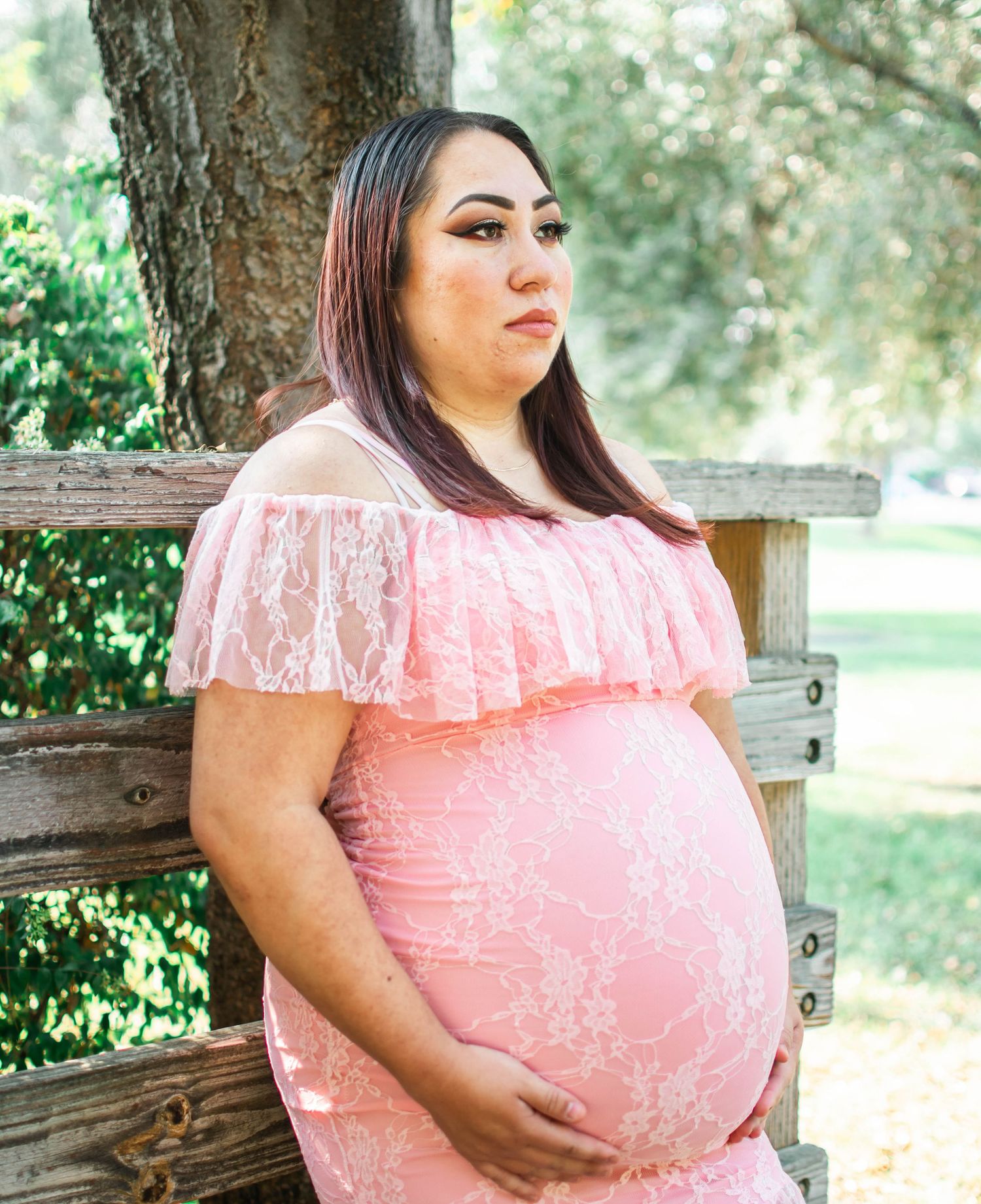 A series of outdoor portrait photos showing someone wearing a pink lace off-shoulder dress against a natural background.