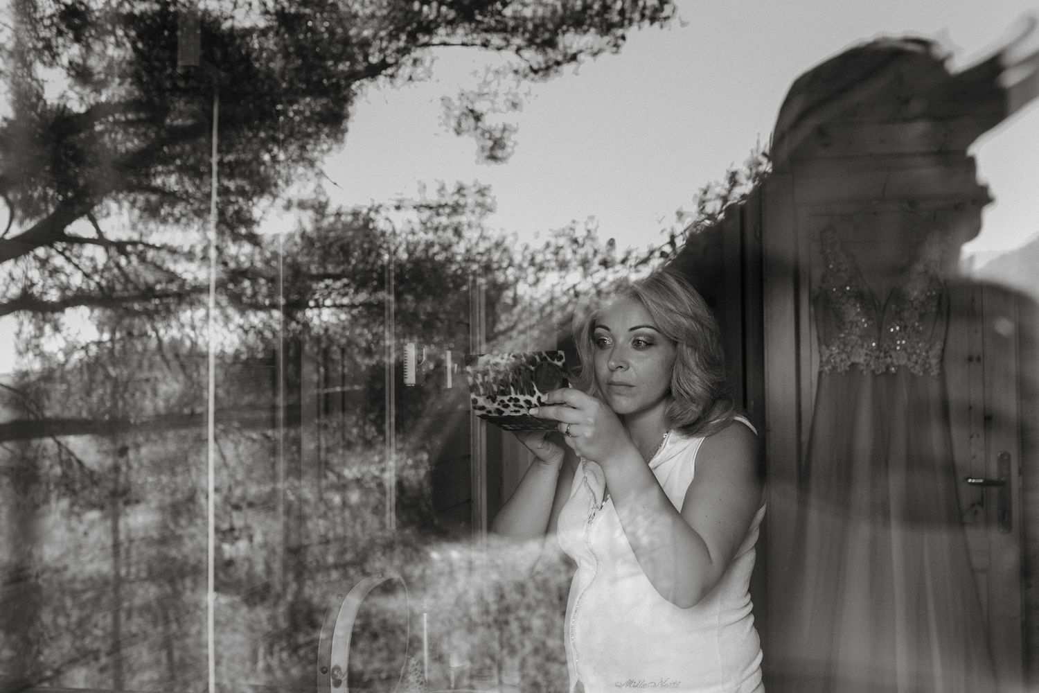 Bride is doing her own make up for a wedding.