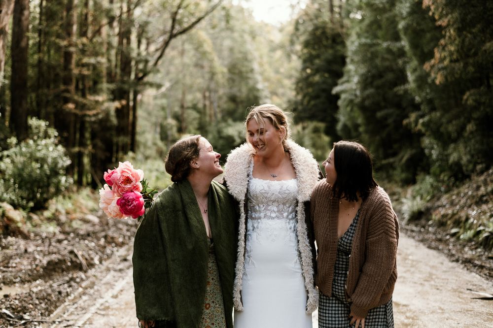 girls having fun on road to Hartz Mountain National Park, Tasmania. captured during an elopement by Joss Jensen Photography