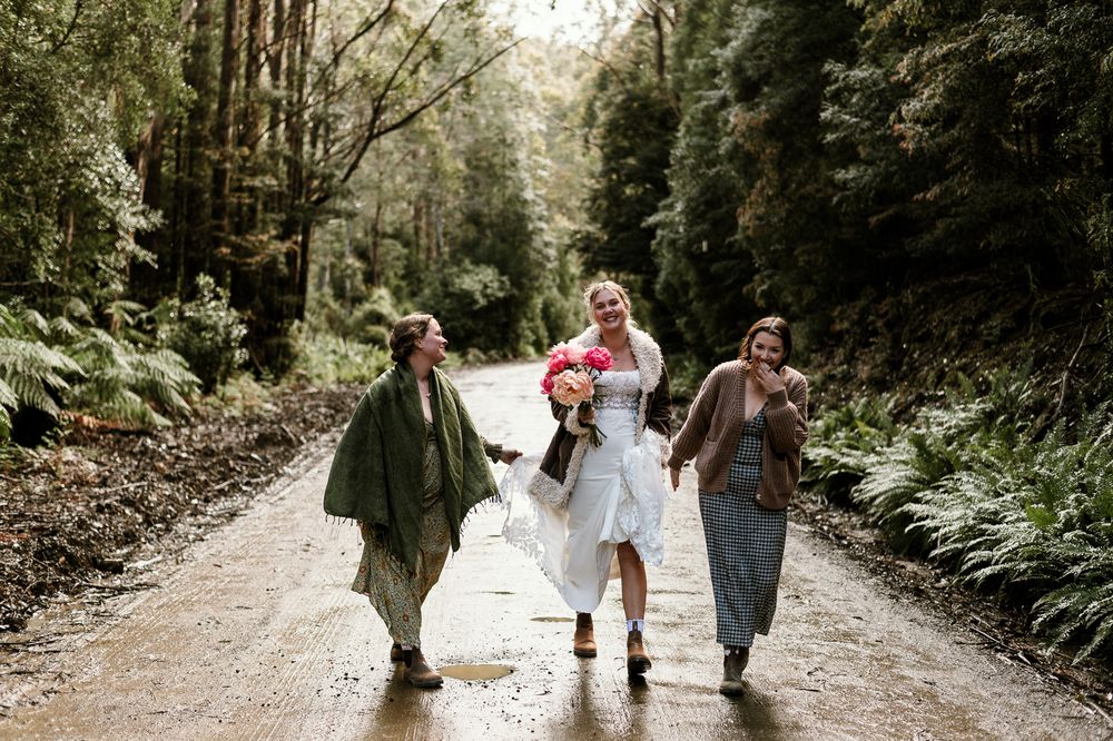 girls having fun on road to Hartz Mountain National Park, Tasmania. captured during an elopement by Joss Jensen Photography