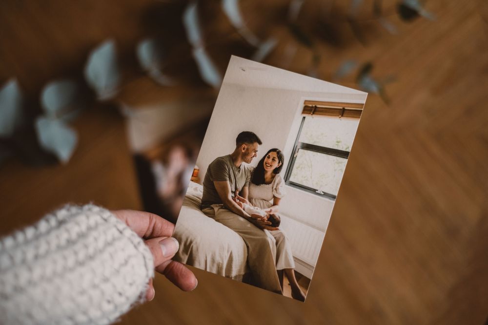 Couple holding hands and embracing in a cozy kitchen while looking lovingly at each other.