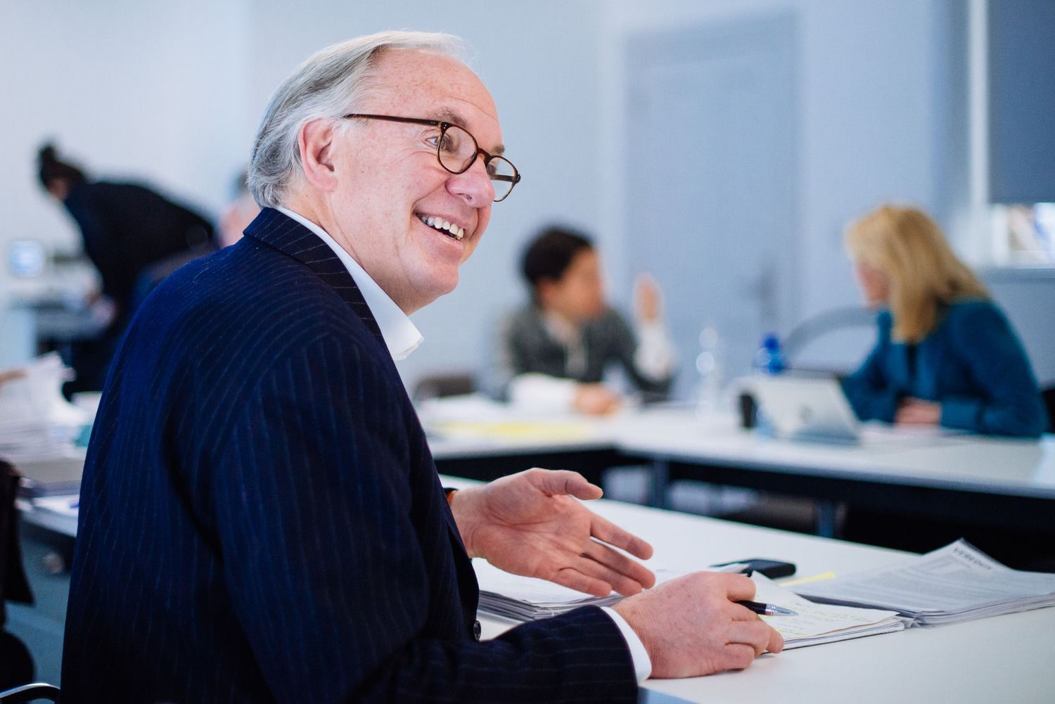 Smiling professional during business meeting in office setting.