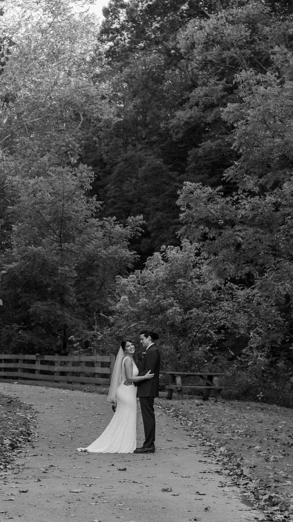 A wedding portrait on a path in the woods