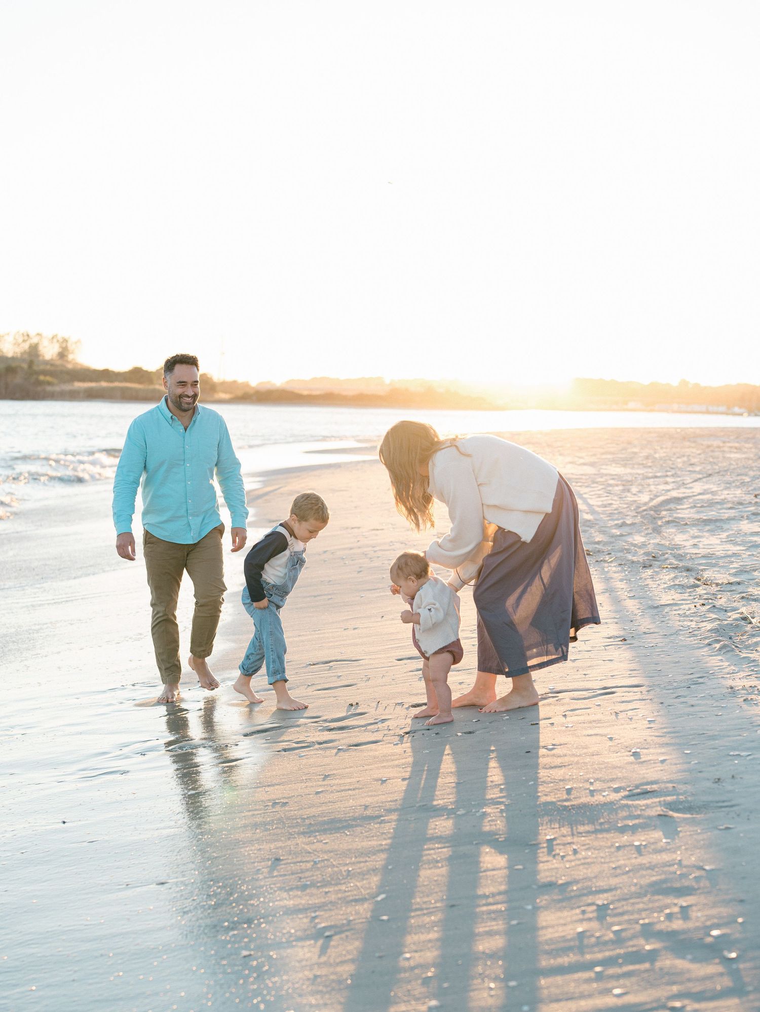 Coastal family portrait in Ocean County, New Jersey, with natural sand and sea backdrop.