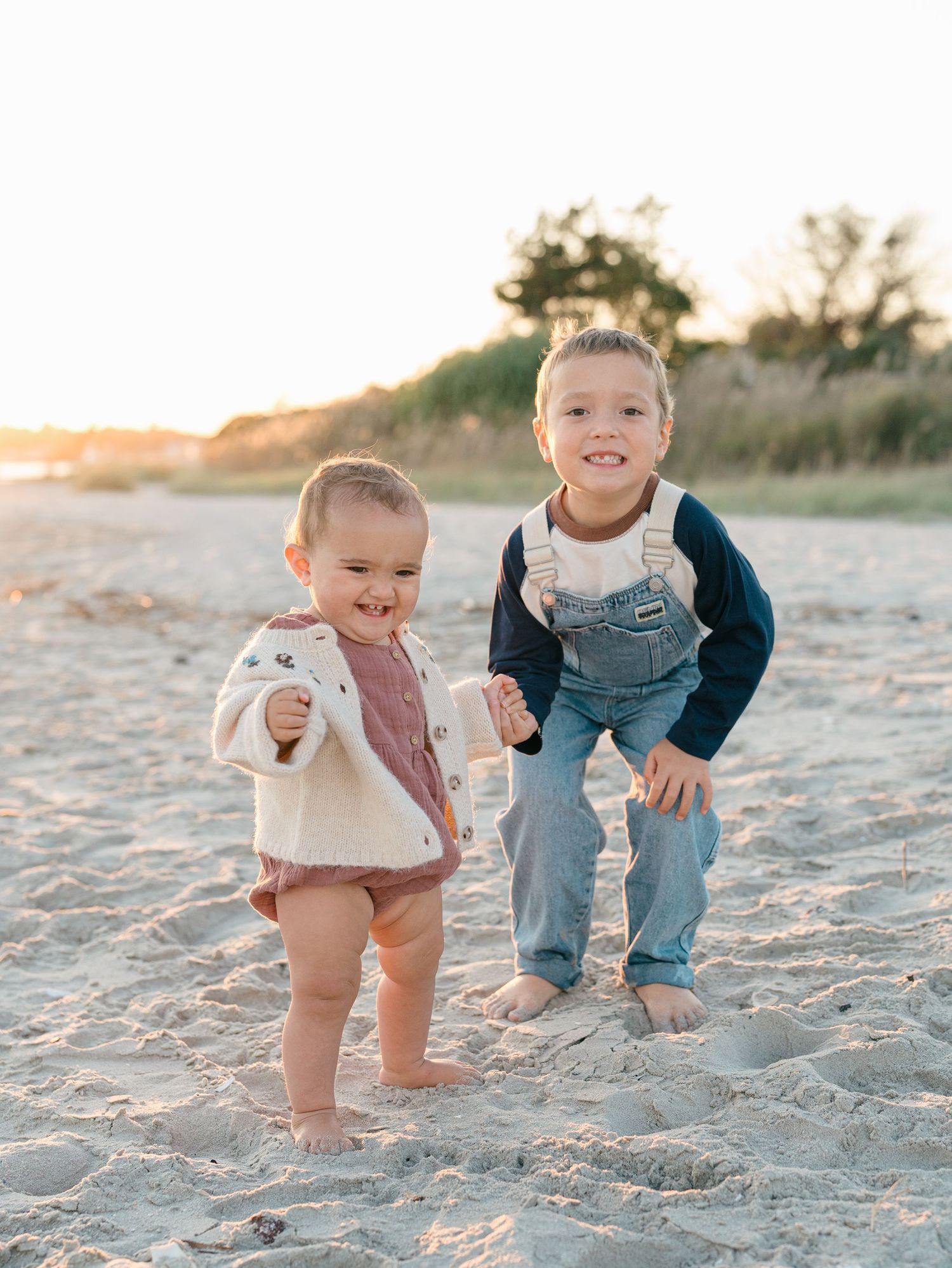 Children exploring Ocean County beach during a refined family photography session.
