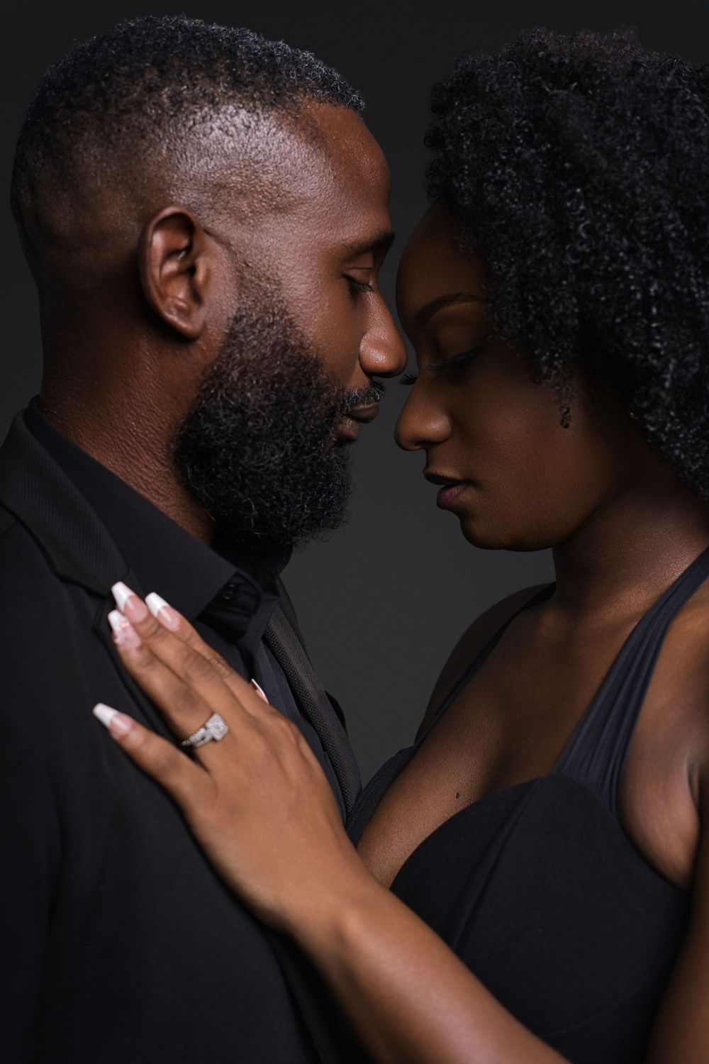 Dramatic black and white series showing intimate moments between couple with focus on emotional connection.