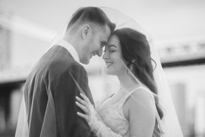 Intimate black and white wedding portraits showing tender moments between newlyweds.