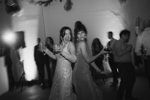 Wedding reception dance floor captured in dramatic black and white lighting.