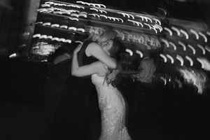 Artistic black and white photo showing movement on a dark dance floor.