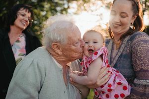 Heartwarming family moment shared between generations in an outdoor setting.