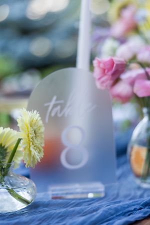 Wedding table decor with delicate floral arrangements and soft blue accents.