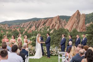 Outdoor wedding ceremony with dramatic red rock formations at Roxborough State Park.