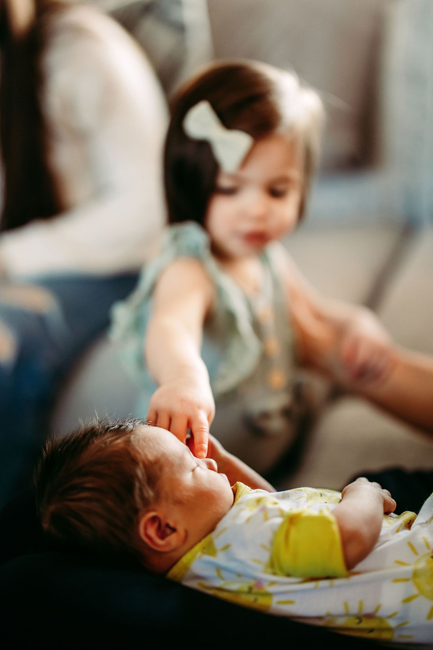 A series of photos showing a sleeping baby being held while two women smile in the background.