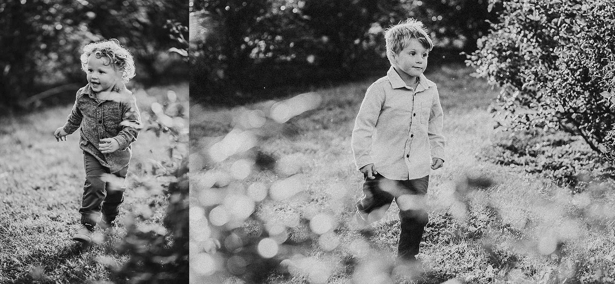 Two kids chase each other through a wooded area in black and white photography.