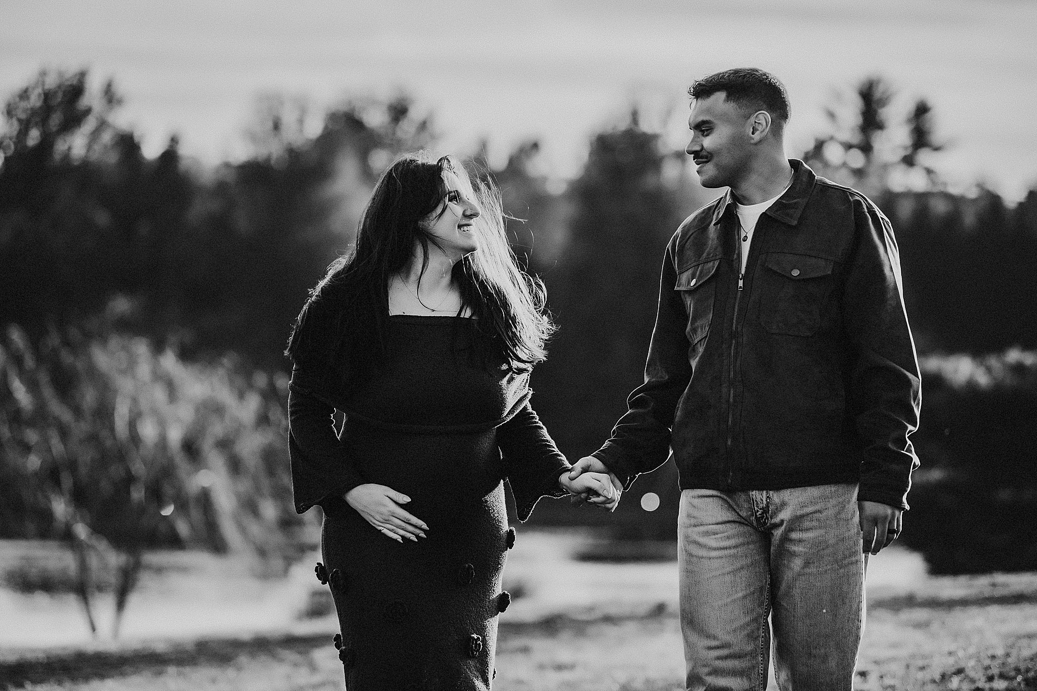 Black and white film strip showing romantic couple embracing in outdoor settings across multiple frames.