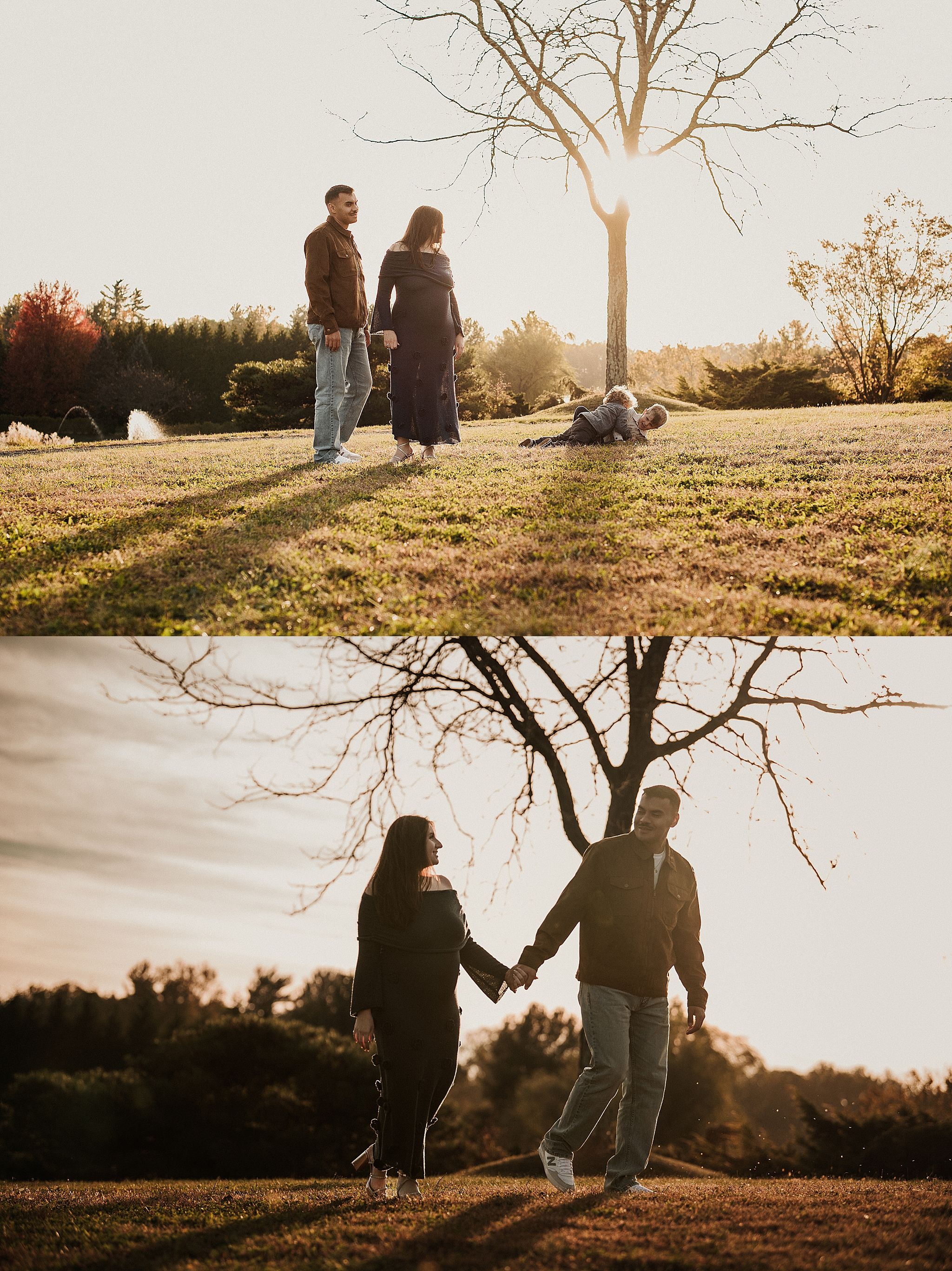 A couple stands silhouetted against a warm sunset on a grassy hilltop with bare trees in the background.