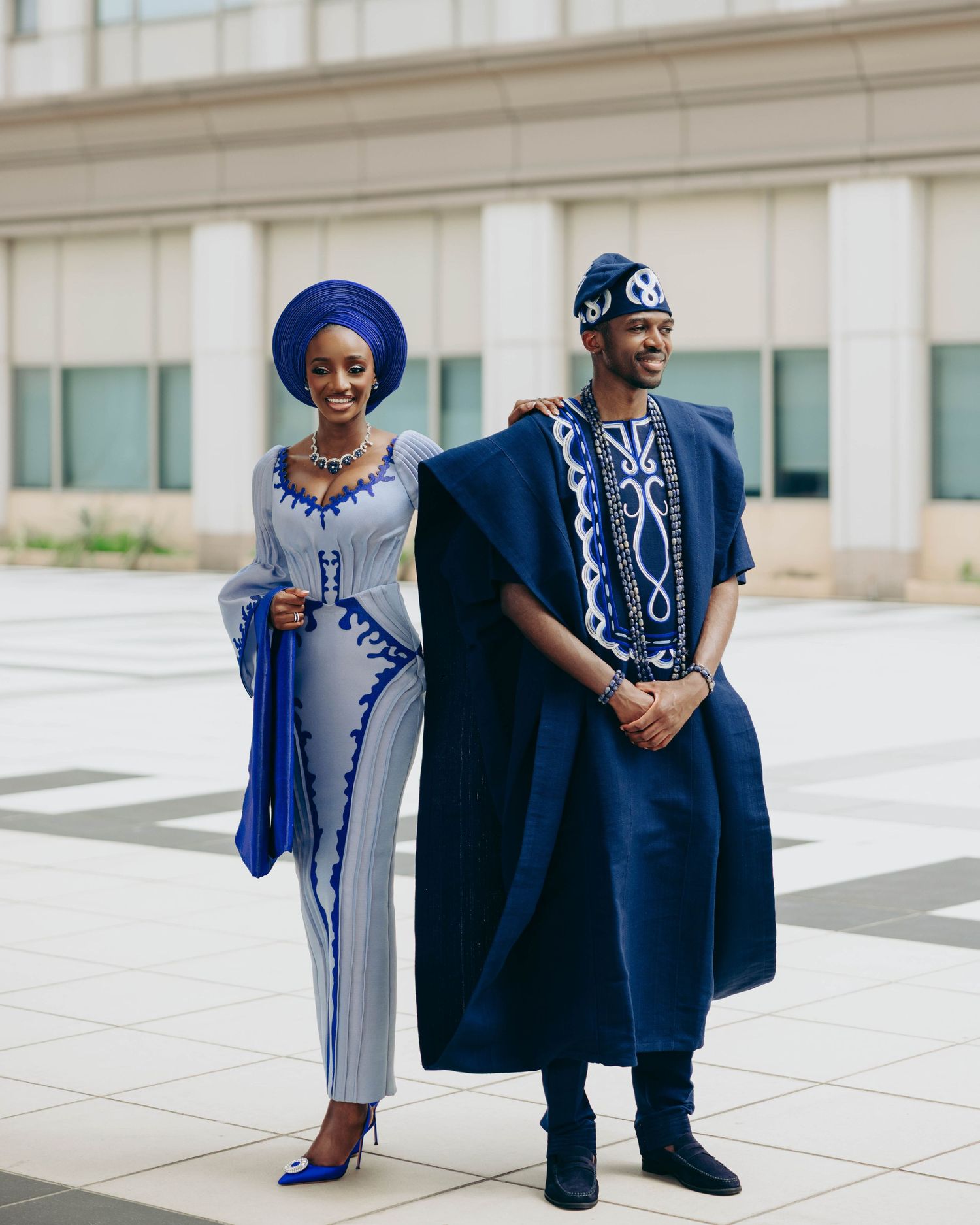 Stylish couple in coordinating navy blue outfits posing together in a series of outdoor fashion photos.