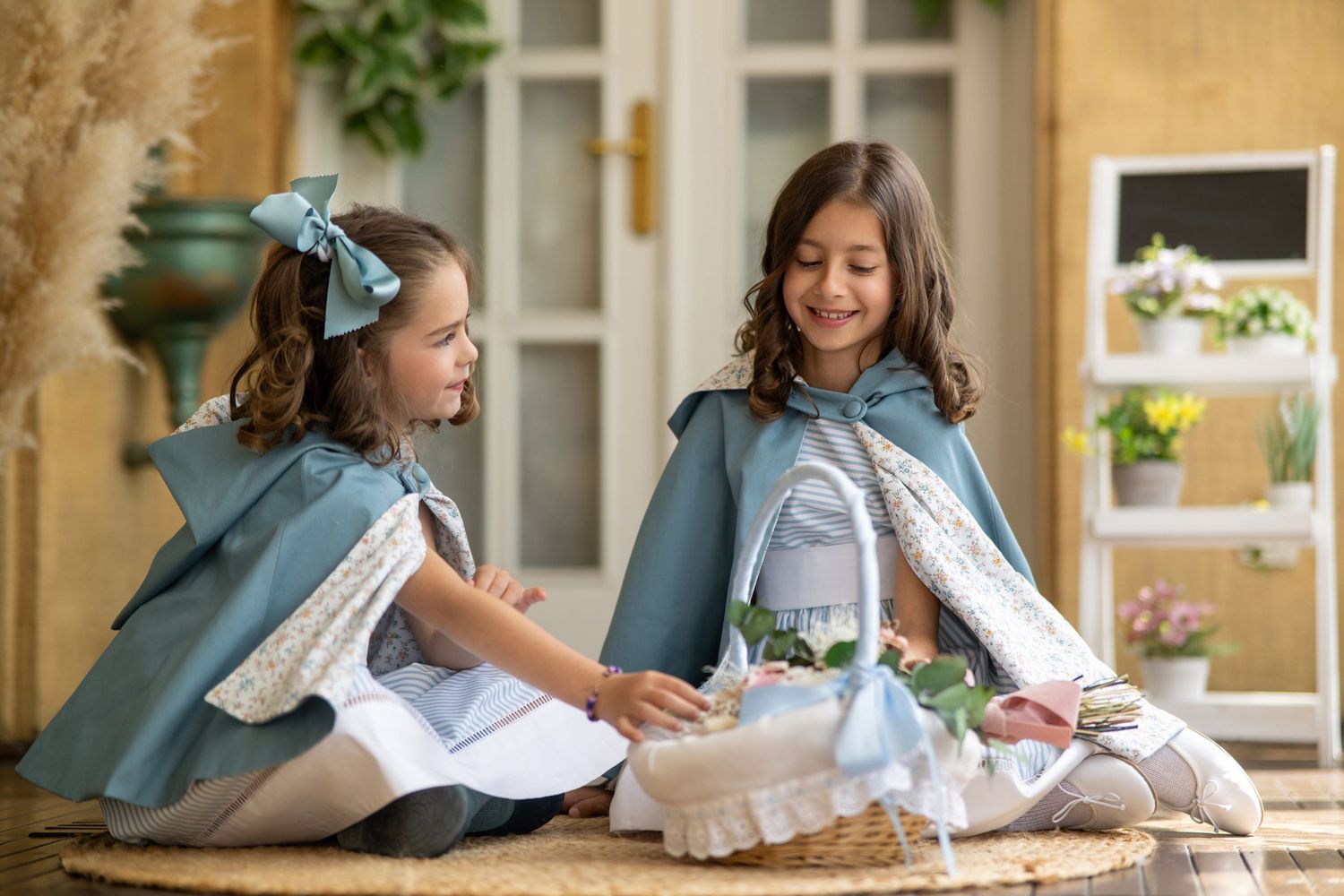 A series of vintage-style photos showing children in white dresses and blue bows sitting and reading books indoors.