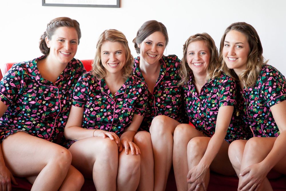 Group wearing matching floral print outfits sitting together in a row.