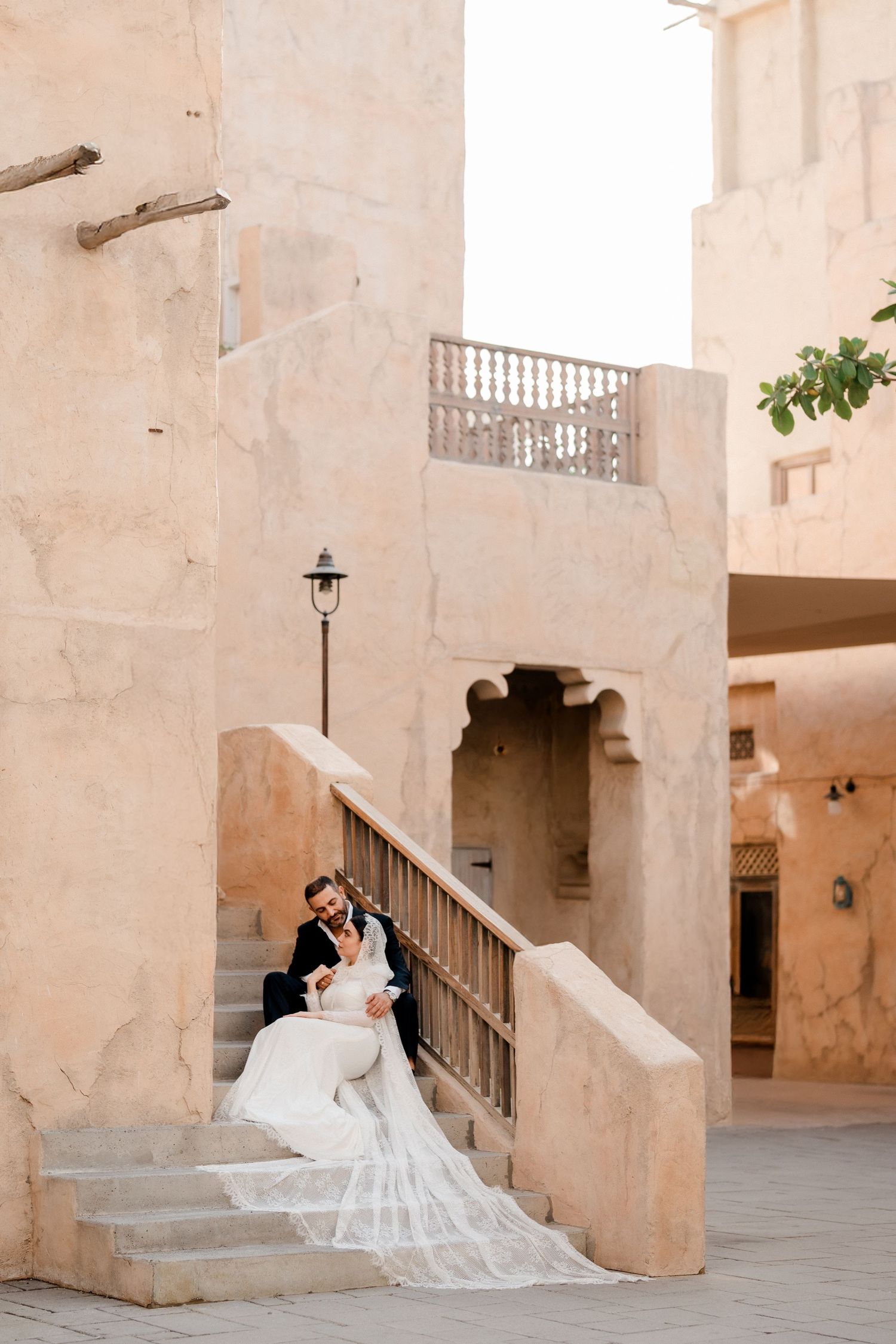 Bride walking up traditional stone staircase during romantic pre-wedding photoshoot