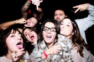 A series of five photo booth style images showing people making silly faces and poses together.