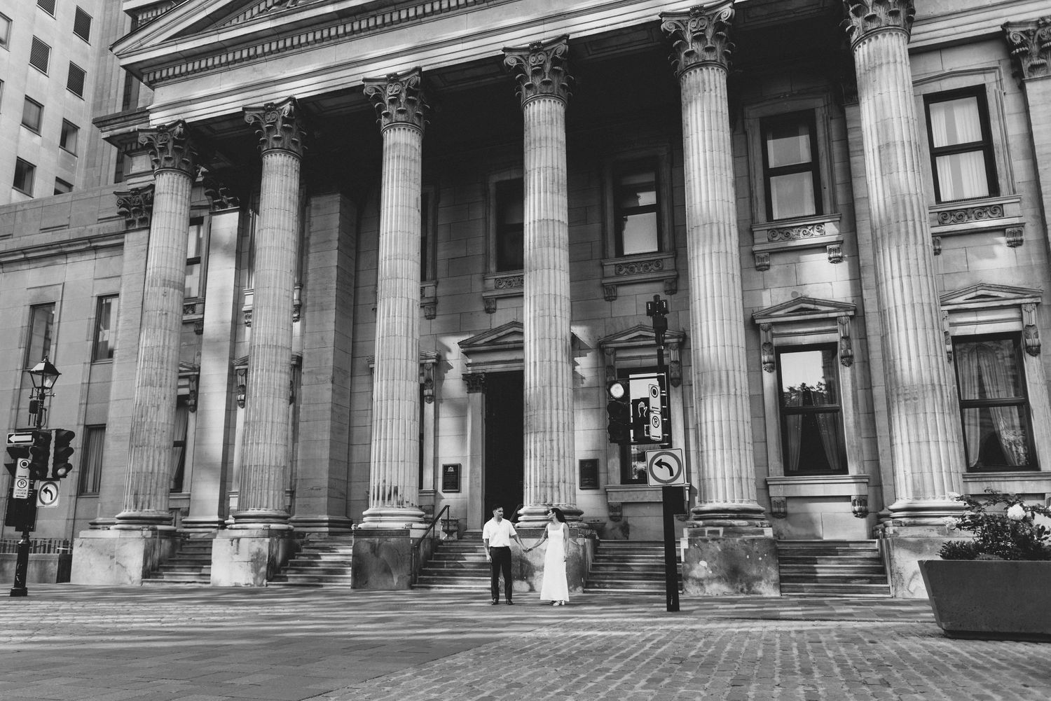 Historic neoclassical building facade with grand white columns and ornate architectural details along its exterior.