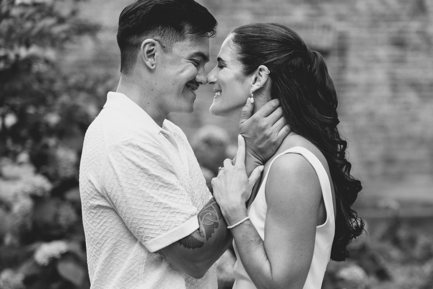 A romantic black and white photo series showing tender moments between a couple in an outdoor setting.