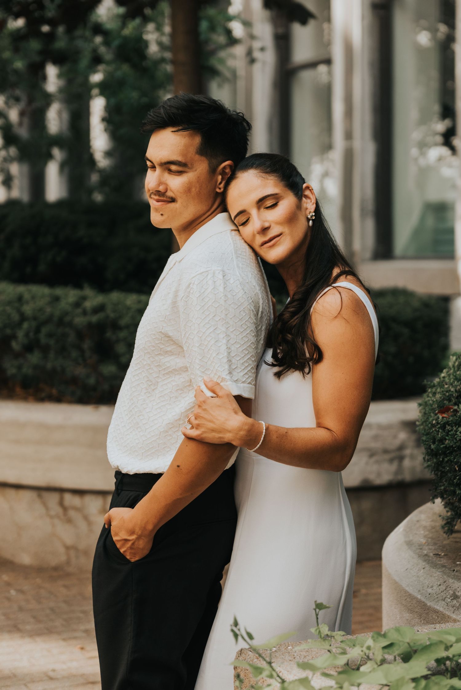 Three intimate wedding photos show tender moments between a couple embracing in an outdoor setting with columns and greenery.